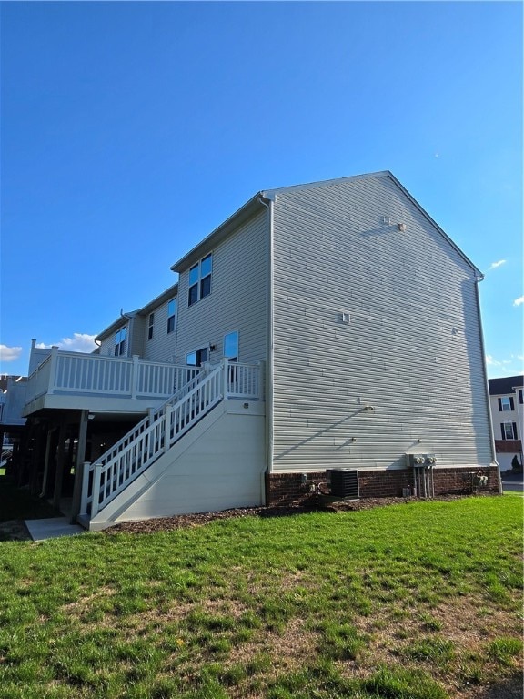 back of house featuring a deck and a yard