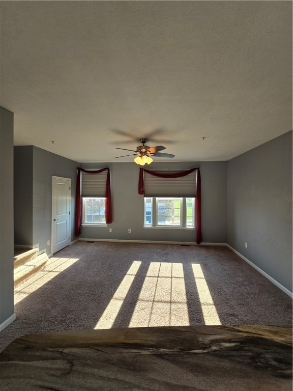 carpeted empty room with ceiling fan