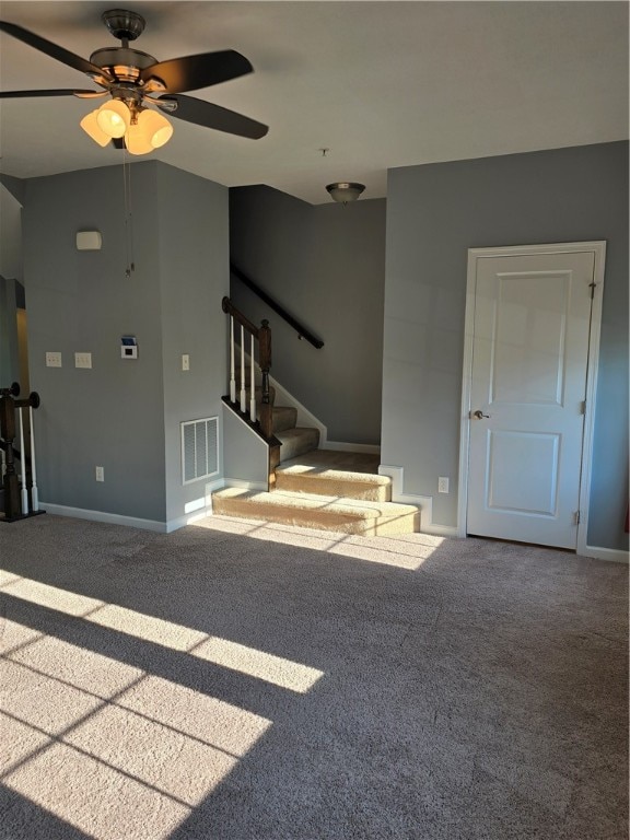 unfurnished living room with carpet flooring and ceiling fan