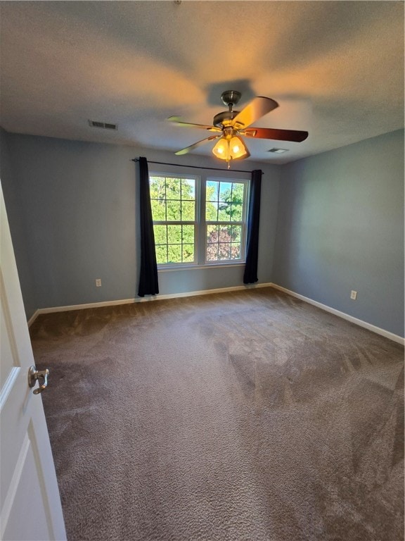 empty room with ceiling fan and carpet floors