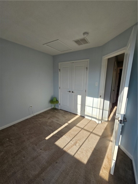 unfurnished bedroom with light carpet and a closet