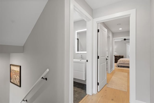 hall featuring light hardwood / wood-style flooring and sink