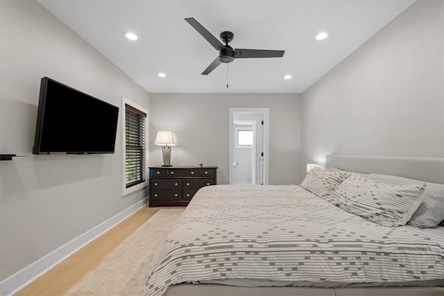 bedroom featuring multiple windows, ceiling fan, and light hardwood / wood-style flooring