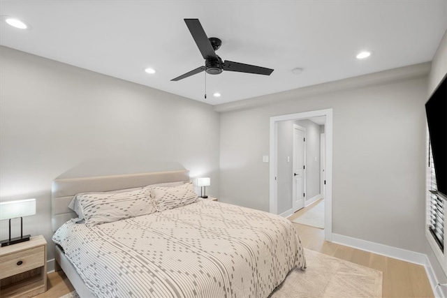 bedroom with light hardwood / wood-style flooring and ceiling fan