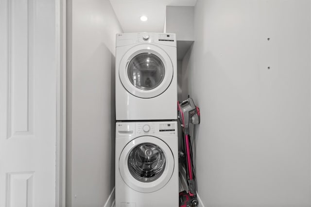 washroom featuring stacked washer / drying machine