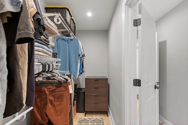 walk in closet featuring light hardwood / wood-style flooring