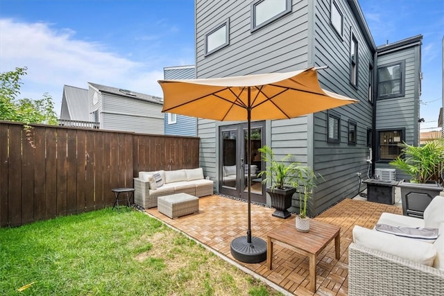 back of property featuring french doors, a patio area, and a lawn