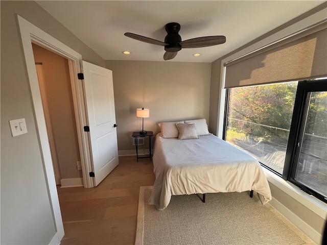 bedroom with light hardwood / wood-style flooring and ceiling fan