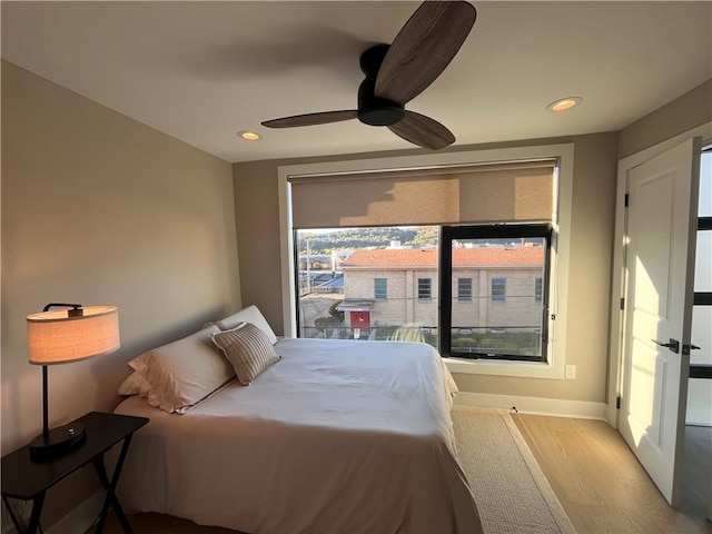 bedroom with light hardwood / wood-style flooring and ceiling fan