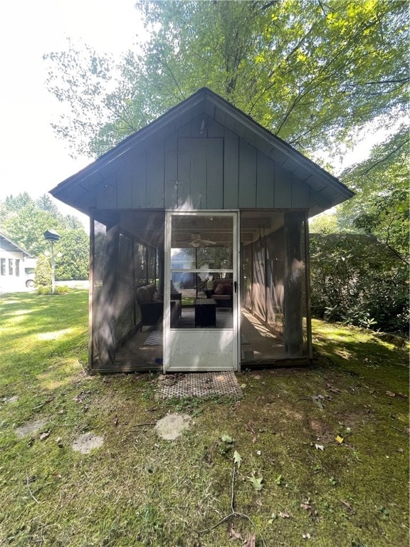 view of outbuilding with a lawn