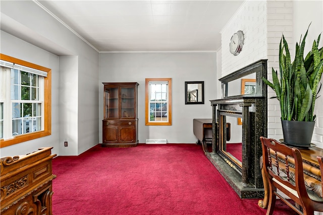 interior space with crown molding, a wealth of natural light, carpet flooring, and brick wall