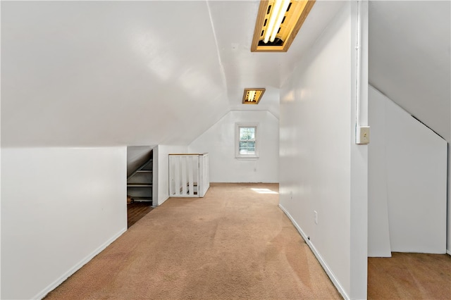 additional living space featuring light carpet and lofted ceiling