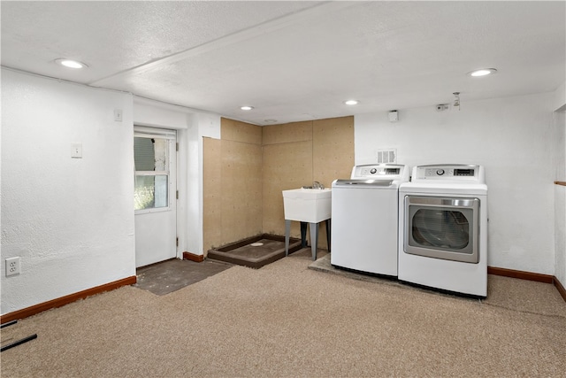 laundry area with sink, carpet floors, and independent washer and dryer