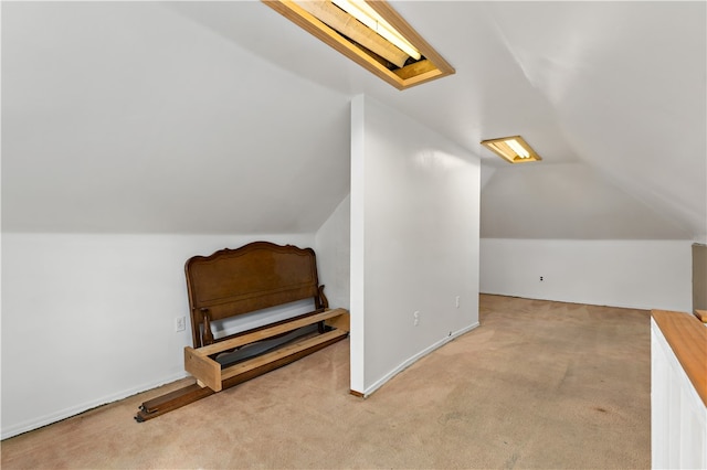 bonus room featuring vaulted ceiling and light carpet