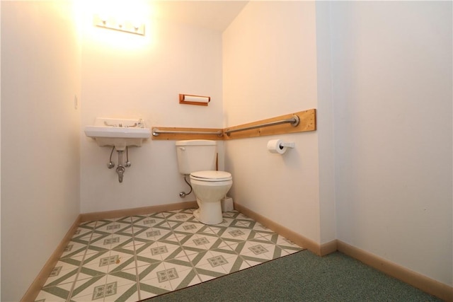 half bathroom with toilet and baseboards