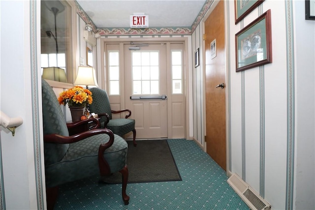 doorway to outside with visible vents and carpet flooring