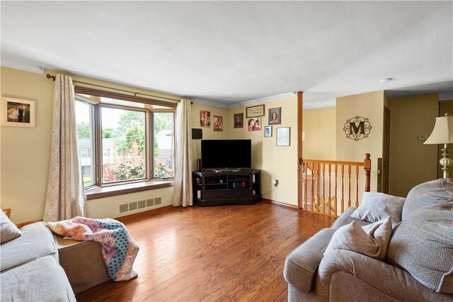 living room featuring hardwood / wood-style flooring and ornamental molding