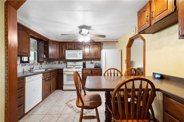 kitchen with backsplash, white appliances, ceiling fan, sink, and light tile patterned floors