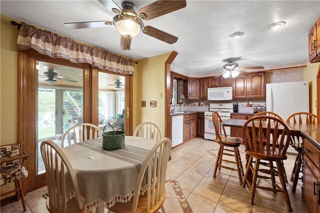 dining area featuring light tile patterned flooring and sink