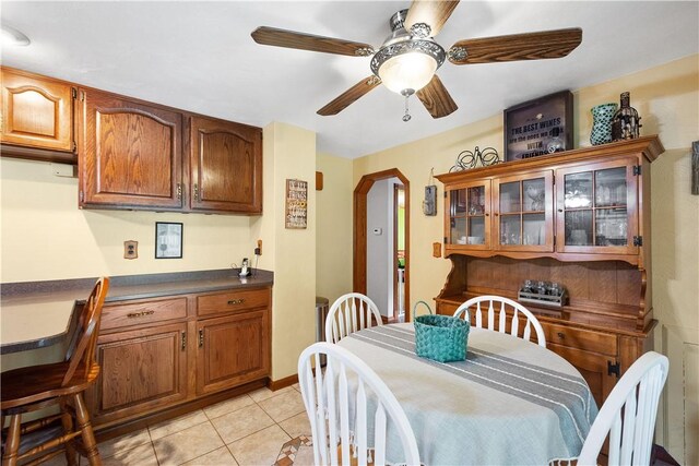 dining room with light tile patterned floors and ceiling fan