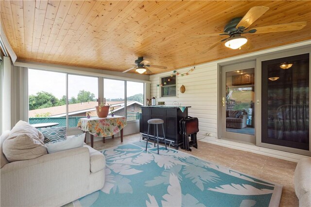 sunroom / solarium featuring ceiling fan and wooden ceiling