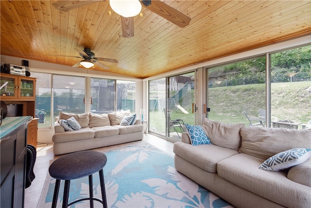 living room featuring ceiling fan, light tile patterned flooring, and wooden ceiling