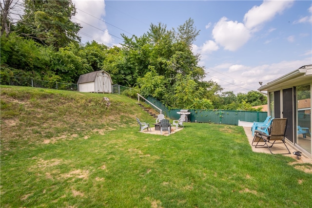 view of yard with a storage unit and an outdoor fire pit