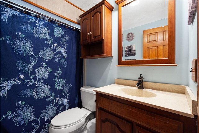 bathroom featuring vanity and toilet