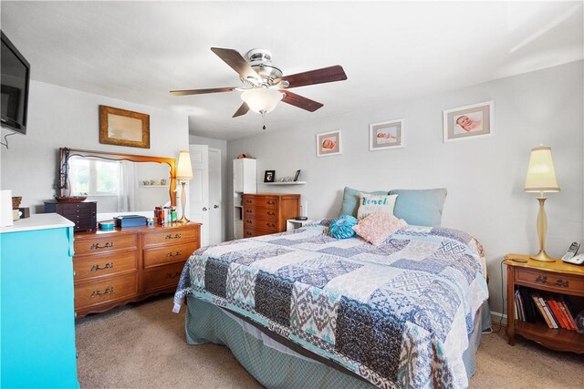 bedroom featuring ceiling fan and light carpet