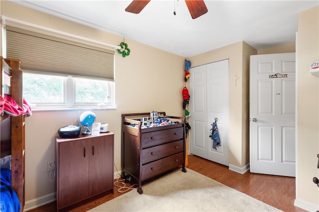 bedroom featuring ceiling fan, a closet, and light wood-type flooring