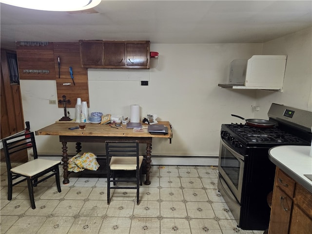 kitchen featuring gas range, a baseboard radiator, and light tile patterned floors