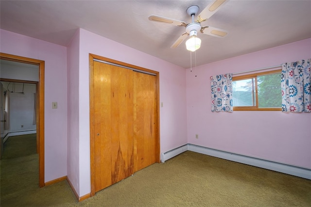 unfurnished bedroom featuring light carpet, a closet, ceiling fan, and baseboard heating