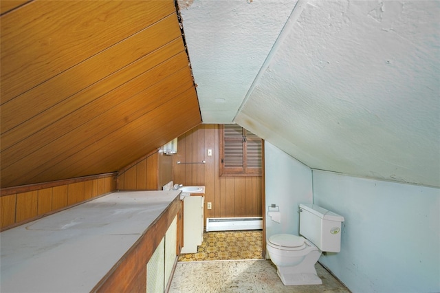 bonus room featuring baseboard heating, a textured ceiling, lofted ceiling, and wooden walls