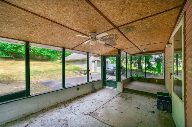 unfurnished sunroom featuring ceiling fan