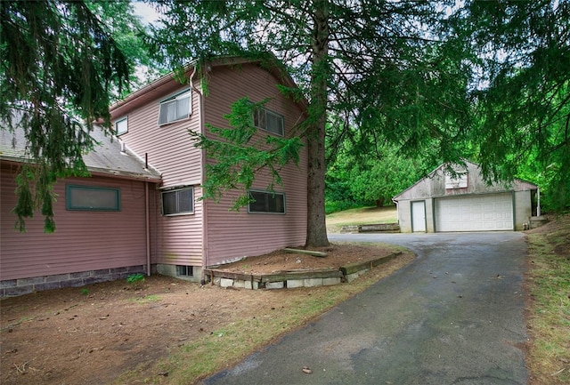 view of home's exterior featuring a garage and an outdoor structure