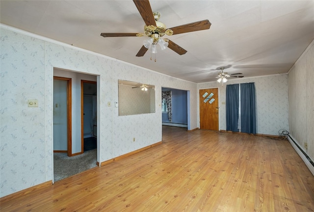 carpeted spare room with a baseboard heating unit and ceiling fan