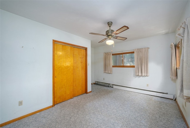 unfurnished bedroom featuring a baseboard radiator, carpet flooring, a closet, and ceiling fan