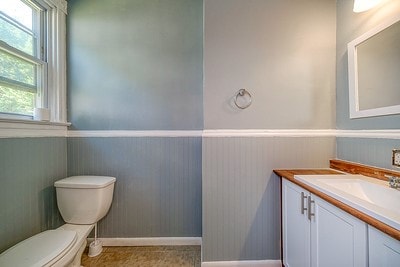 bathroom with toilet, tile patterned floors, and vanity