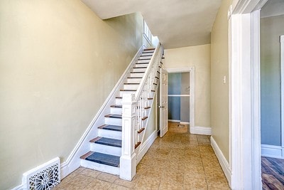 stairs with tile patterned flooring