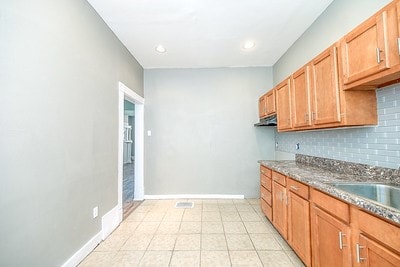 kitchen featuring light tile patterned flooring and decorative backsplash