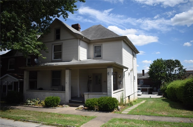 view of front of property with a porch and a front yard