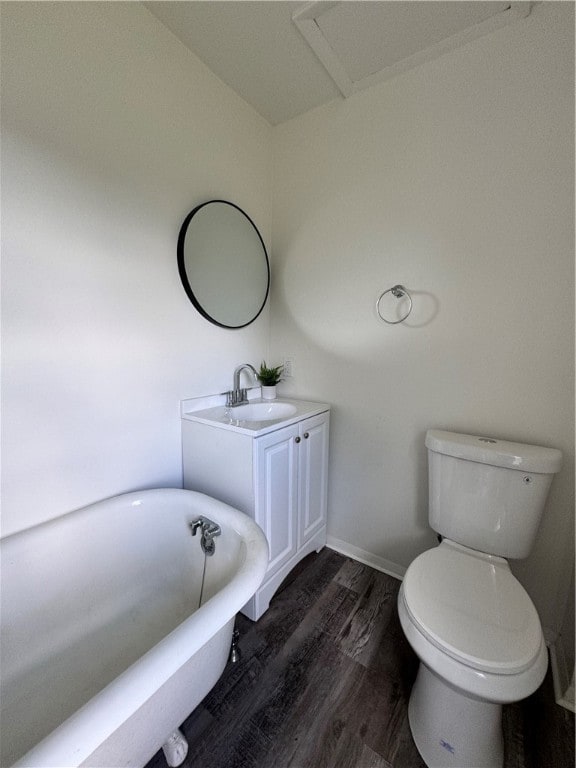 bathroom featuring a bath, toilet, sink, and wood-type flooring