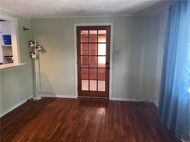 doorway to outside featuring dark hardwood / wood-style floors and a textured ceiling