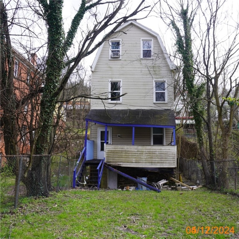 back of house with a lawn