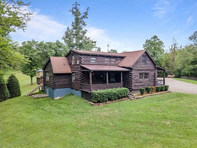 back of house with a lawn