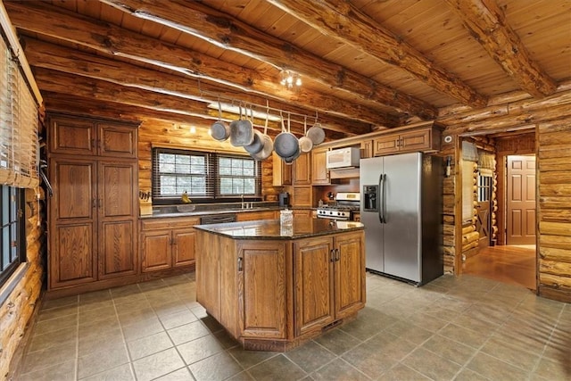 kitchen featuring appliances with stainless steel finishes, wood ceiling, dark stone countertops, beamed ceiling, and a center island