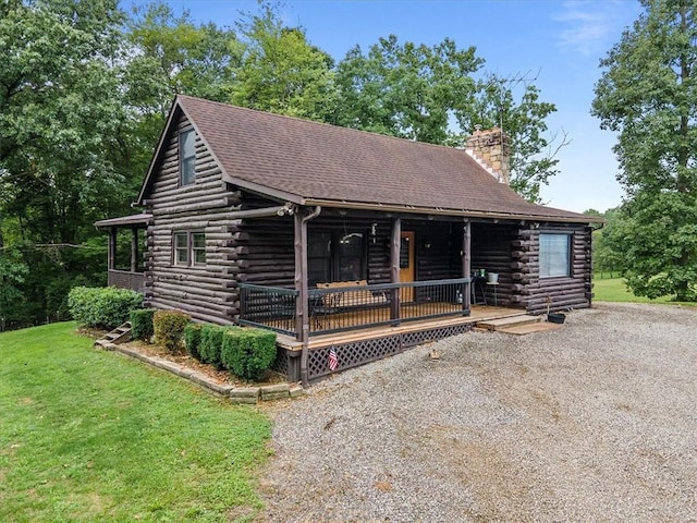 log cabin with a front lawn and a porch