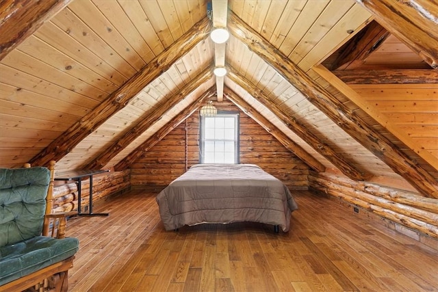 bedroom featuring hardwood / wood-style flooring, vaulted ceiling with beams, and wood ceiling