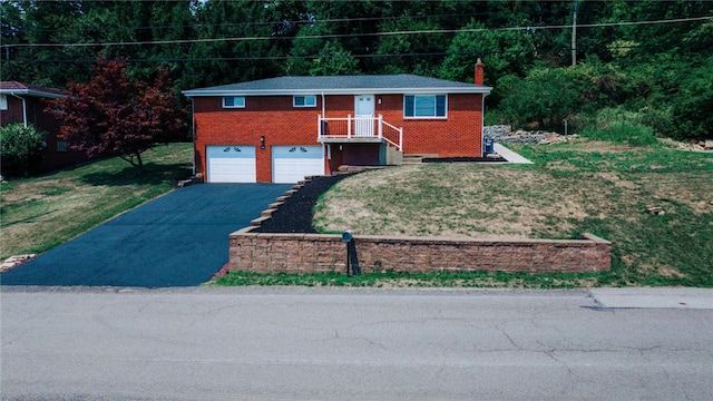 view of front of house with a front lawn and a garage