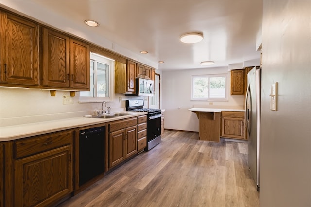 kitchen featuring appliances with stainless steel finishes, dark hardwood / wood-style floors, and sink